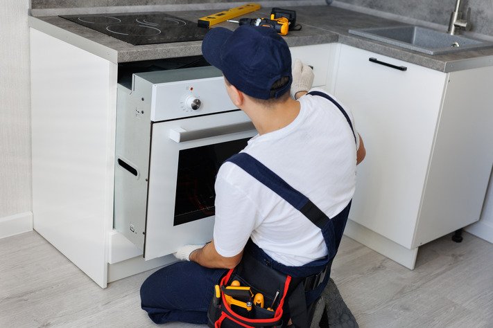 man-installs-an-oven-after-assembling-the-kitchen-2025-01-10-20-40-45-utc man-installs-an-oven-after-assembling-the-kitchen-2025-01-10-20-40-45-utc